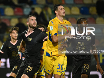 Thomas Henry of Palermo F.C., Ilario Monterisi of Frosinone Calcio, and Salim Diakite of Palermo F.C. participate during the 13th day of the...