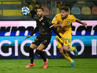 Roberto Insigne of Palermo F.C. and Gabriele Bracaglia of Frosinone Calcio are in action during the 13th day of the Serie BKT Championship b...