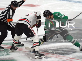 Wyatt Johnston #53 of the Dallas Stars faces off against Jason Dickinson #16 of the Chicago Blackhawks during the NHL match at American Airl...