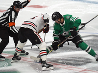 Wyatt Johnston #53 of the Dallas Stars faces off against Jason Dickinson #16 of the Chicago Blackhawks during the NHL match at American Airl...