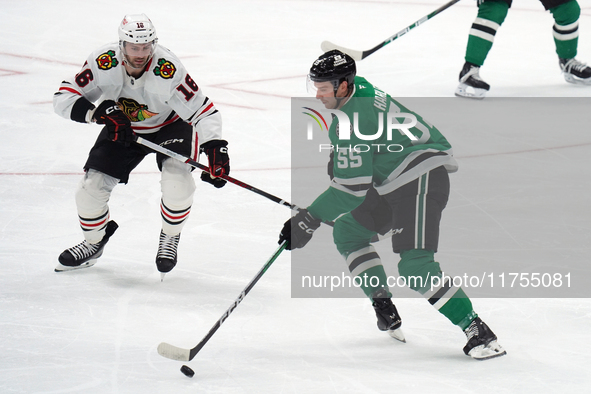 Thomas Harley #55 of the Dallas Stars and Jason Dickinson #16 of the Chicago Blackhawks battle for the puck during the NHL match at American...