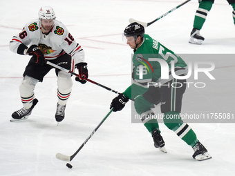 Thomas Harley #55 of the Dallas Stars and Jason Dickinson #16 of the Chicago Blackhawks battle for the puck during the NHL match at American...