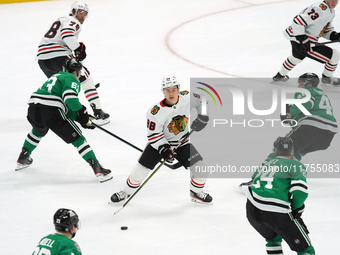 Connor Bedard #98 of the Chicago Blackhawks controls the puck during the NHL match against the Dallas Stars at American Airlines Center in D...