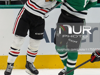 Wyatt Kaiser #44 of the Chicago Blackhawks hits Oskar Back #10 of the Dallas Stars during the NHL match at American Airlines Center in Dalla...