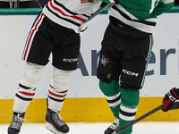 Wyatt Kaiser #44 of the Chicago Blackhawks hits Oskar Back #10 of the Dallas Stars during the NHL match at American Airlines Center in Dalla...