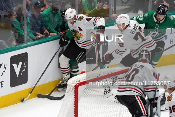 Seth Jones #4 and Alex Vlasic #72 of the Chicago Blackhawks go for the puck during the NHL match against the Dallas Stars at American Airlin...