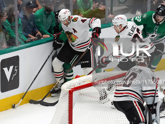 Seth Jones #4 and Alex Vlasic #72 of the Chicago Blackhawks go for the puck during the NHL match against the Dallas Stars at American Airlin...