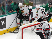 Seth Jones #4 and Alex Vlasic #72 of the Chicago Blackhawks go for the puck during the NHL match against the Dallas Stars at American Airlin...