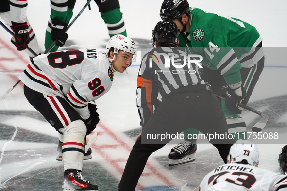 Jamie Benn #14 of the Dallas Stars faces off against Connor Bedard #98 of the Chicago Blackhawks during the NHL match at American Airlines C...