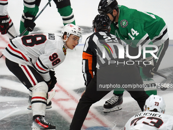 Jamie Benn #14 of the Dallas Stars faces off against Connor Bedard #98 of the Chicago Blackhawks during the NHL match at American Airlines C...