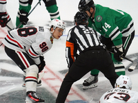 Jamie Benn #14 of the Dallas Stars faces off against Connor Bedard #98 of the Chicago Blackhawks during the NHL match at American Airlines C...