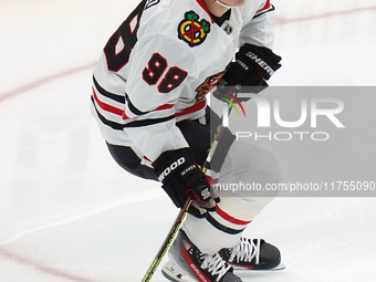 Connor Bedard #98 of the Chicago Blackhawks skates on the ice while driving forward with the puck during the NHL match against the Dallas St...