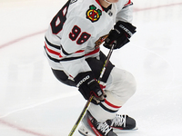 Connor Bedard #98 of the Chicago Blackhawks skates on the ice while driving forward with the puck during the NHL match against the Dallas St...