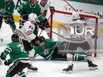 Roope Hintz #24 of the Dallas Stars slides in front of the goal to prevent the Chicago Blackhawks from scoring during the NHL match at Ameri...