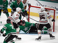 Roope Hintz #24 of the Dallas Stars slides in front of the goal to prevent the Chicago Blackhawks from scoring during the NHL match at Ameri...