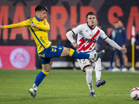 Pep Chavarria of Rayo Vallecano (R) is in action against Manu Fuster of UD Las Palmas (L) during the La Liga EA Sports 2024/25 football matc...