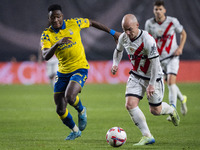 Isi Palazon of Rayo Vallecano (R) is in action against Dario Essugo of UD Las Palmas (L) during the La Liga EA Sports 2024/25 football match...