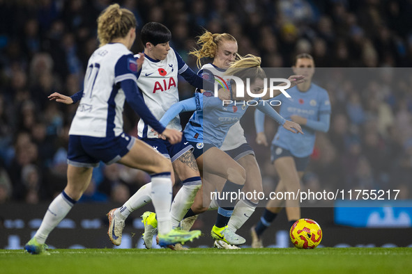 Lauren Hemp #11 of Manchester City W.F.C. is tackled by the opponents during the Barclays FA Women's Super League match between Manchester C...