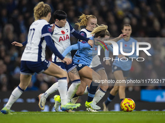 Lauren Hemp #11 of Manchester City W.F.C. is tackled by the opponents during the Barclays FA Women's Super League match between Manchester C...