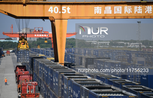 A gantry crane lifts containers at the Nanchang International Dry Port in Nanchang, Jiangsu province, China, on November 7, 2024. 