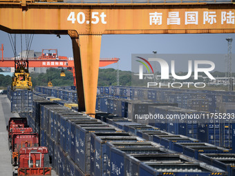 A gantry crane lifts containers at the Nanchang International Dry Port in Nanchang, Jiangsu province, China, on November 7, 2024. (