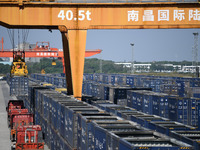 A gantry crane lifts containers at the Nanchang International Dry Port in Nanchang, Jiangsu province, China, on November 7, 2024. (