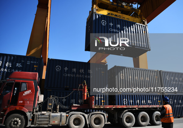 A gantry crane lifts containers at the Nanchang International Dry Port in Nanchang, Jiangsu province, China, on November 7, 2024. 