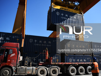 A gantry crane lifts containers at the Nanchang International Dry Port in Nanchang, Jiangsu province, China, on November 7, 2024. (