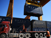 A gantry crane lifts containers at the Nanchang International Dry Port in Nanchang, Jiangsu province, China, on November 7, 2024. (