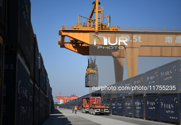 A gantry crane lifts containers at the Nanchang International Dry Port in Nanchang, Jiangsu province, China, on November 7, 2024. 