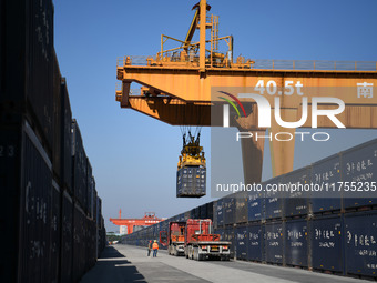 A gantry crane lifts containers at the Nanchang International Dry Port in Nanchang, Jiangsu province, China, on November 7, 2024. (