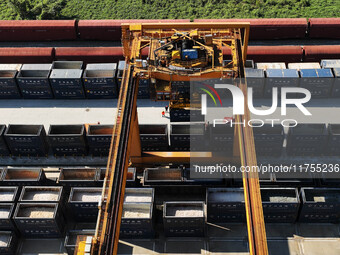 A gantry crane lifts containers at the Nanchang International Dry Port in Nanchang, Jiangsu province, China, on November 7, 2024. (