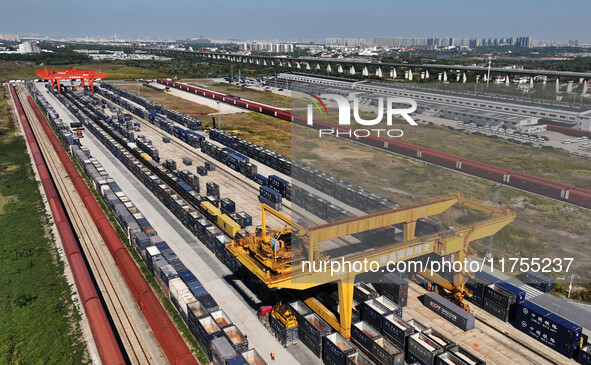 A gantry crane lifts containers at the Nanchang International Dry Port in Nanchang, Jiangsu province, China, on November 7, 2024. 