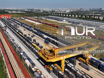 A gantry crane lifts containers at the Nanchang International Dry Port in Nanchang, Jiangsu province, China, on November 7, 2024. (