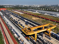 A gantry crane lifts containers at the Nanchang International Dry Port in Nanchang, Jiangsu province, China, on November 7, 2024. (