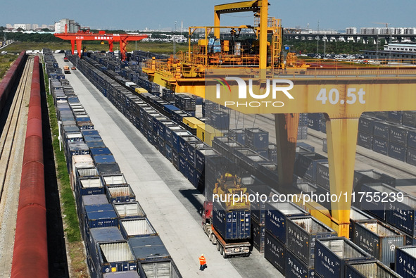 A gantry crane lifts containers at the Nanchang International Dry Port in Nanchang, Jiangsu province, China, on November 7, 2024. 