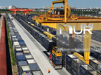 A gantry crane lifts containers at the Nanchang International Dry Port in Nanchang, Jiangsu province, China, on November 7, 2024. (