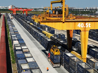 A gantry crane lifts containers at the Nanchang International Dry Port in Nanchang, Jiangsu province, China, on November 7, 2024. (