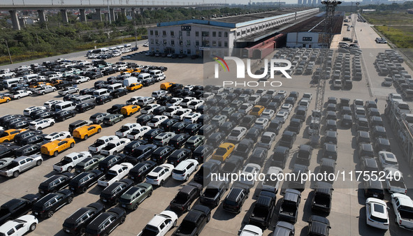 A staff member moves a commercial vehicle into a JSQ type special carriage at Nanchang International Dry Port in Nanchang, Jiangsu province,...