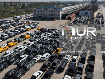 A staff member moves a commercial vehicle into a JSQ type special carriage at Nanchang International Dry Port in Nanchang, Jiangsu province,...