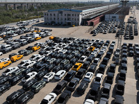 A staff member moves a commercial vehicle into a JSQ type special carriage at Nanchang International Dry Port in Nanchang, Jiangsu province,...