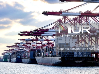 A large container ship conducts container operations at a berth at the Qianwan Container Terminal of Qingdao Port in Qingdao, China, on Nove...