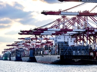 A large container ship conducts container operations at a berth at the Qianwan Container Terminal of Qingdao Port in Qingdao, China, on Nove...