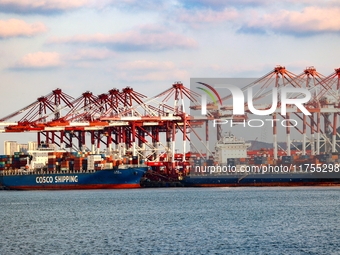 A large container ship conducts container operations at a berth at the Qianwan Container Terminal of Qingdao Port in Qingdao, China, on Nove...