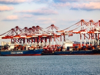 A large container ship conducts container operations at a berth at the Qianwan Container Terminal of Qingdao Port in Qingdao, China, on Nove...