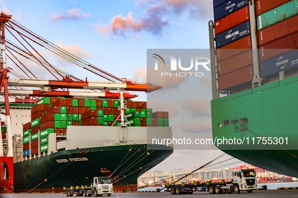 A large container ship conducts container operations at a berth at the Qianwan Container Terminal of Qingdao Port in Qingdao, China, on Nove...