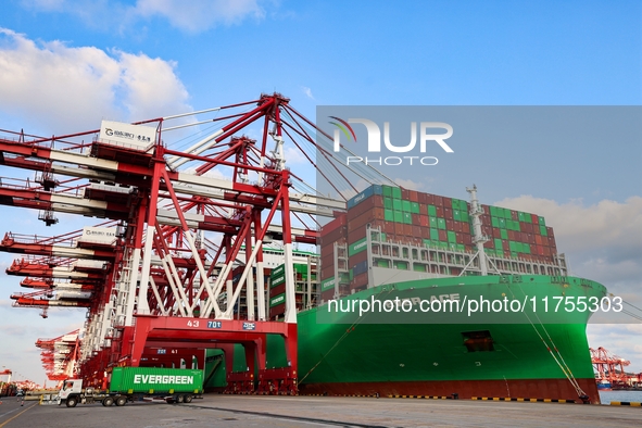 A global super-class container ship unloads containers at the Qianwan container terminal of Qingdao Port in Qingdao, China, on November 8, 2...