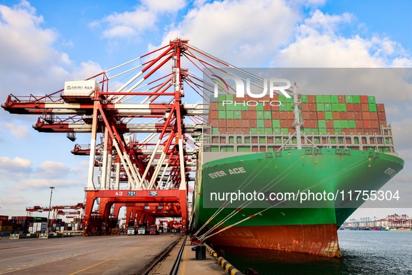 A global super-class container ship unloads containers at the Qianwan container terminal of Qingdao Port in Qingdao, China, on November 8, 2...