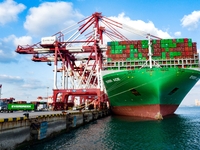 A global super-class container ship unloads containers at the Qianwan container terminal of Qingdao Port in Qingdao, China, on November 8, 2...