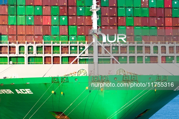 A global super-class container ship unloads containers at the Qianwan container terminal of Qingdao Port in Qingdao, China, on November 8, 2...